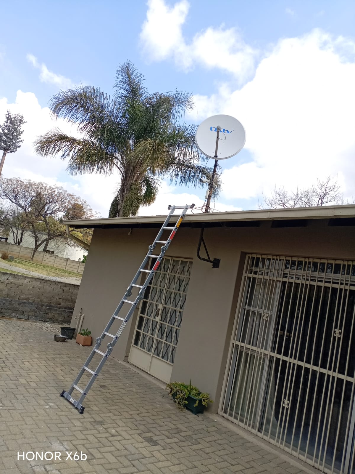DStv technician completing a service call in Claremont